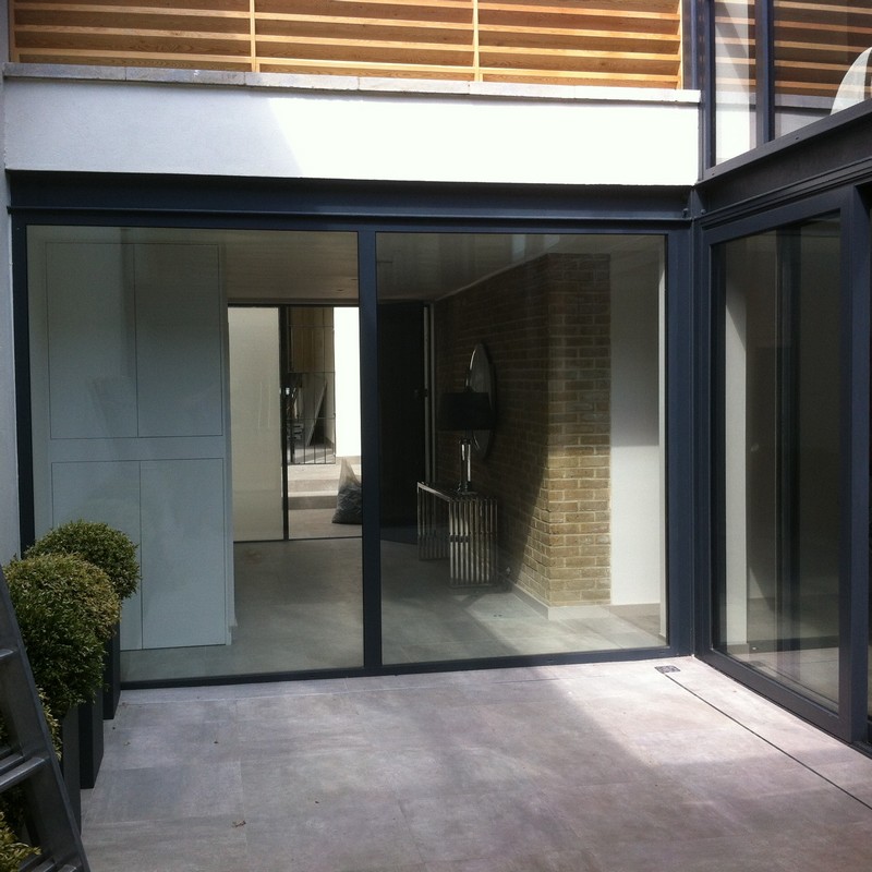 Floor-to-ceiling sliding doors opening to courtyard in Wembley