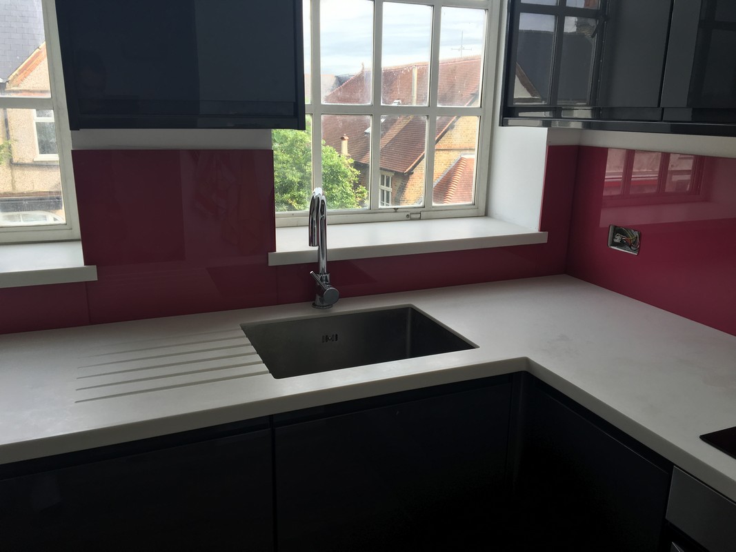 Deep plum coloured glass splashback in modern Wembley kitchen